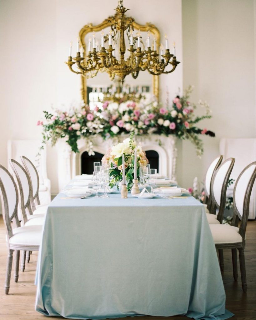 Somewhere between the grand, playful pink installation over the fireplace and the beautifully laid tablescape in a pastel palette, we