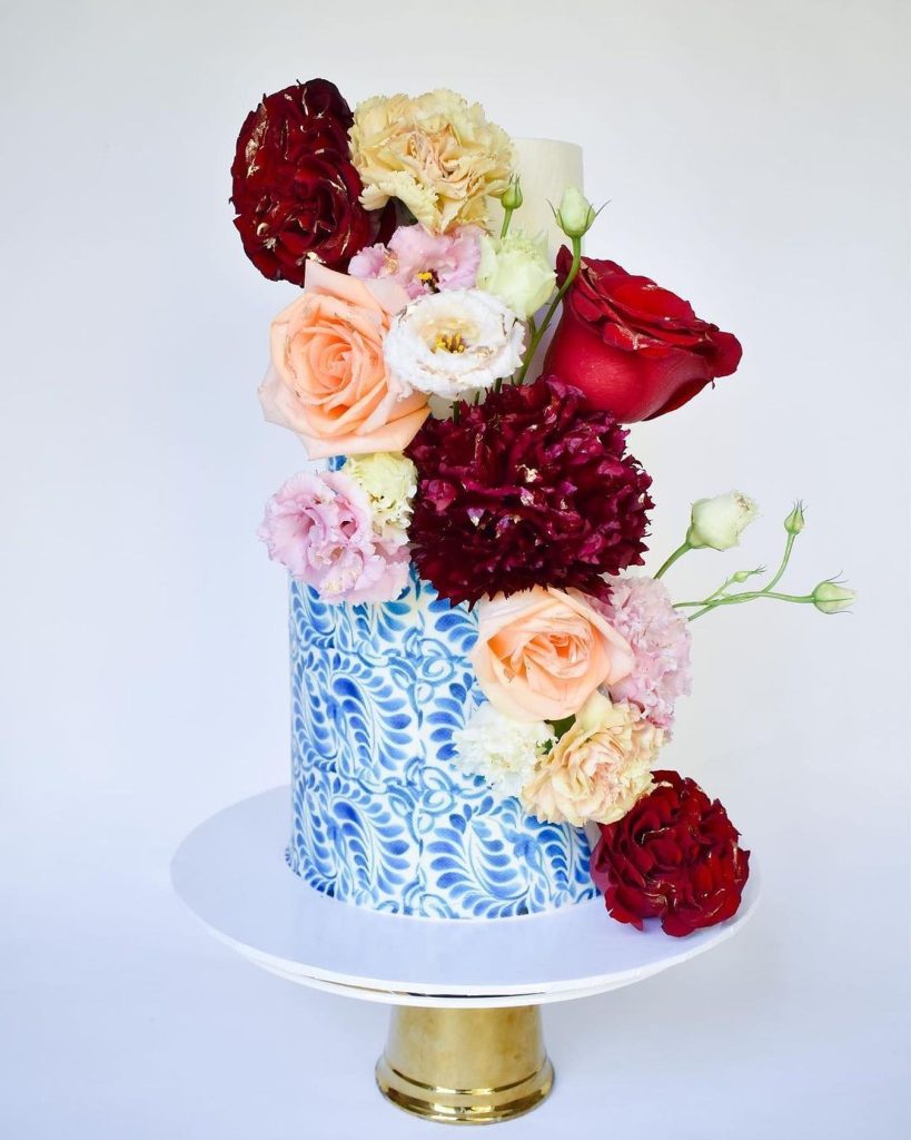 With it's iced, blue details and fresh florals this two-tiered wedding cake from marblelouscakes⁠ will forever take our breath away!